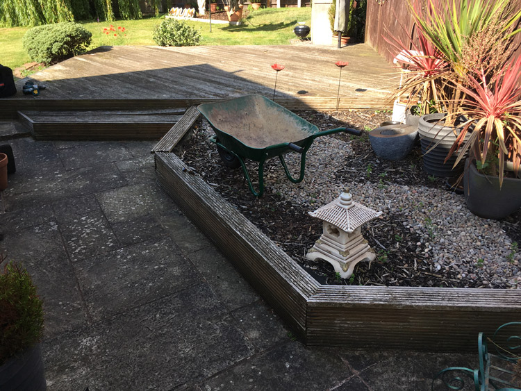 before picture of Wooden flower bed and decking by neat borders landscape gardening